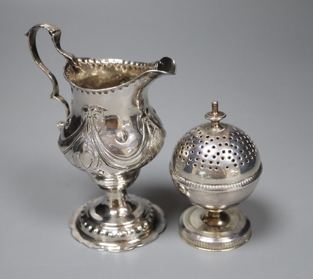 A George III silver inverted pear shaped cream jug, London, 1779 and a George III silver globe shaped pedestal pepperette